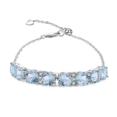 Row of Round Cut Natural Blue Topaz Silver Bracelet