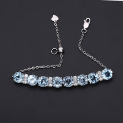 Row of Round Cut Natural Blue Topaz Silver Bracelet